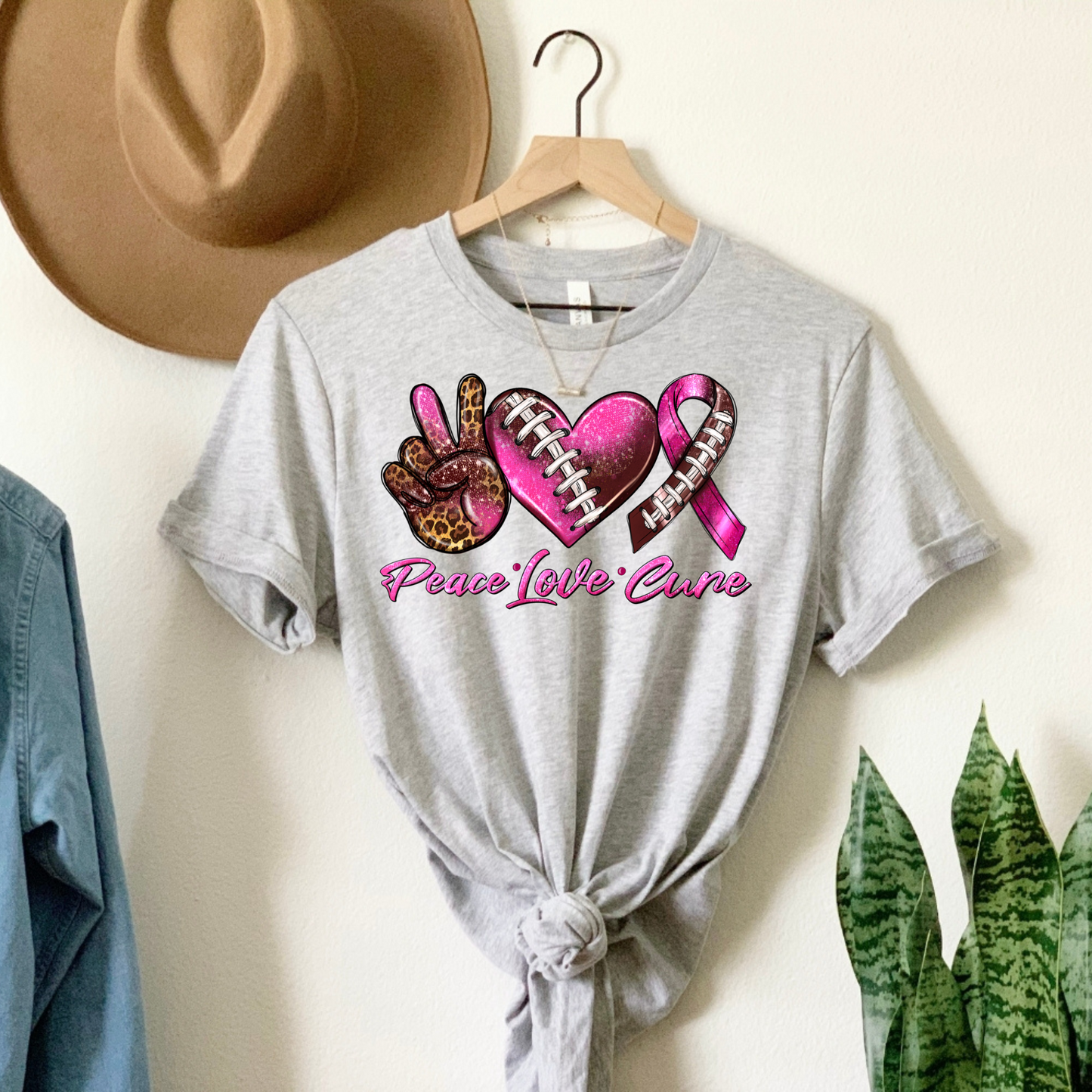 Score for Hope: 'Peace Love Cure' Cancer Football Tee